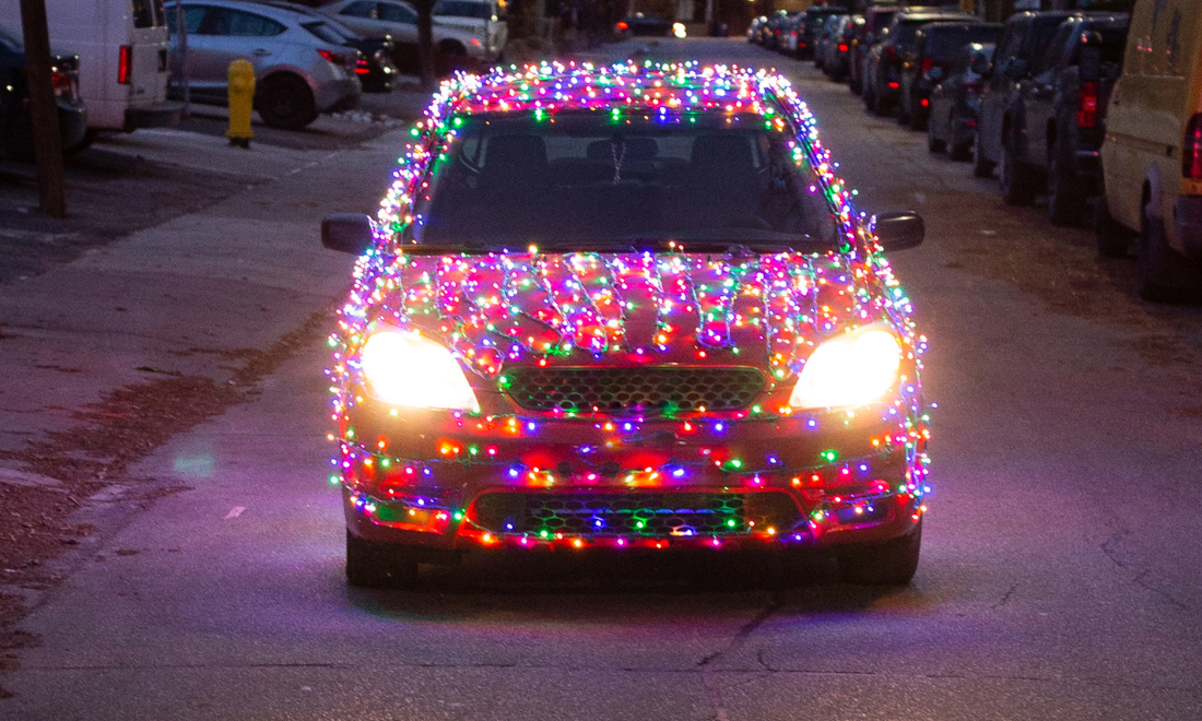 Car decorated with lights and Christmas tree seen on Dutch roads